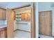 Walk-in pantry offering ample storage space with wooden shelves and cabinets, ideal for organization at 2585 E Egbert St, Brighton, CO 80601