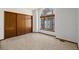 Bedroom with large arched window and closet with sliding doors at 1829 S Pitkin Cir, Aurora, CO 80017