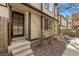 Front entrance featuring a secure black metal door, complementing the home's exterior with landscaped yard at 1829 S Pitkin Cir, Aurora, CO 80017