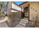 Home's front entrance with secure black metal door, landscaped yard, and stone pathway to the front door at 1829 S Pitkin Cir, Aurora, CO 80017