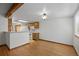The kitchen opens to a dining area with hardwood floors and natural light from a window, creating a cozy atmosphere at 1829 S Pitkin Cir, Aurora, CO 80017