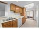 Functional kitchen design featuring stainless steel sink, dishwasher, and convenient access to the outdoor area at 1829 S Pitkin Cir, Aurora, CO 80017