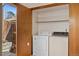 Laundry room features a washer, dryer, shelving, and sliding doors at 1829 S Pitkin Cir, Aurora, CO 80017