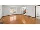 Bright living room featuring hardwood floors, a large window and staircase, creating a warm and inviting atmosphere at 1829 S Pitkin Cir, Aurora, CO 80017