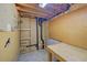 Unfinished basement area with workbench and exposed pipes at 2713 W Long Dr # C, Littleton, CO 80120