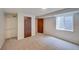 Basement bedroom featuring a double closet, carpeting, and a standard window at 2713 W Long Dr # C, Littleton, CO 80120