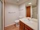 Compact bathroom featuring a single sink vanity, a standard toilet, and tile-trimmed shower stall at 2713 W Long Dr # C, Littleton, CO 80120