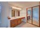 Bathroom vanity with a large mirror and lighting, plus mirrored closet doors at 2713 W Long Dr # C, Littleton, CO 80120