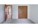 Bedroom featuring neutral carpeting, a wood closet, and view to an adjacent room at 2713 W Long Dr # C, Littleton, CO 80120