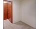 Bedroom with neutral carpet and a door to an adjacent room at 2713 W Long Dr # C, Littleton, CO 80120