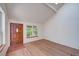Open living space with hardwood floors, a beautiful front door, and ample natural light at 2713 W Long Dr # C, Littleton, CO 80120