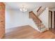 Spacious living room with hardwood floors, a staircase, and ample natural light at 2713 W Long Dr # C, Littleton, CO 80120