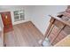 Bright living room features wood floors, a brick accent, and a staircase with wood and brick details at 2713 W Long Dr # C, Littleton, CO 80120