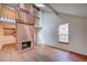 Sunlit living room featuring a cozy fireplace, vaulted ceiling, and hardwood floors at 2713 W Long Dr # C, Littleton, CO 80120