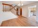 Open-concept living room with hardwood floors, staircase, and easy access to the kitchen at 2713 W Long Dr # C, Littleton, CO 80120
