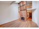 Bright living room with high ceilings, a brick fireplace, and hardwood floors at 2713 W Long Dr # C, Littleton, CO 80120