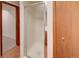 Shower stall with glass door, adjacent to a wood door and carpeted hallway at 2713 W Long Dr # C, Littleton, CO 80120