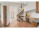 Hallway featuring wood railing, hardwood floors, and stairs to the upper level at 1011 Thames St, Highlands Ranch, CO 80126