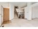 Spacious living room with a staircase, wood accents, and neutral carpeting at 1011 Thames St, Highlands Ranch, CO 80126