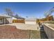 View of fenced backyard with shed, concrete parking pad, and landscaping at 3016 S Grape Way, Denver, CO 80222
