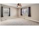 Carpeted bedroom features natural light from windows at 3016 S Grape Way, Denver, CO 80222