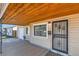 Covered front entrance showcasing a secure iron gate and a peek at the adjacent garage at 3016 S Grape Way, Denver, CO 80222
