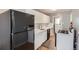 Galley kitchen with modern appliances, white cabinets and marble backsplash at 3016 S Grape Way, Denver, CO 80222