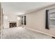 Spacious living room features carpeted floors, a fireplace and natural light at 3016 S Grape Way, Denver, CO 80222