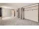 Bright living room features carpeted floors and open closets at 3016 S Grape Way, Denver, CO 80222