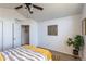 Bright bedroom features modern decor, ceiling fan, and light gray wood-look flooring at 3260 E 103Rd Pl # 912, Thornton, CO 80229
