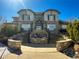 Stunning home exterior with professional landscaping, water feature, and elegant stone accents at 3260 E 103Rd Pl # 912, Thornton, CO 80229