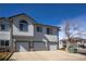 Attached garages and a mix of vinyl siding and stone accents give this townhome curb appeal at 3260 E 103Rd Pl # 912, Thornton, CO 80229