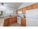 Efficient kitchen includes light countertops, white appliances, and light wood cabinets, bright sunny window at 3260 E 103Rd Pl # 912, Thornton, CO 80229