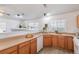 Efficient kitchen includes light countertops, white appliances, light wood cabinets, and a breakfast bar at 3260 E 103Rd Pl # 912, Thornton, CO 80229