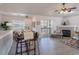 Living room showcases a dining table, sliding glass door to balcony, fireplace, and sleek gray laminate flooring at 3260 E 103Rd Pl # 912, Thornton, CO 80229