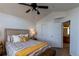 Main bedroom features a ceiling fan, en suite bath, neutral colors, and sleek laminate flooring at 3260 E 103Rd Pl # 912, Thornton, CO 80229