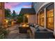 Relaxing back patio area with stone flooring, comfortable seating, a fire pit, and manicured landscaping at 848 S Emerson St, Denver, CO 80209
