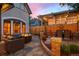 Outdoor living space with a stone patio, comfortable seating, a fire pit, and a pergola with a dining area at 848 S Emerson St, Denver, CO 80209