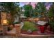 Tranquil backyard featuring a cozy egg chair, hammock, manicured lawn, and decorative landscaping at 848 S Emerson St, Denver, CO 80209