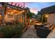 Inviting backyard patio with pergola, string lights, and cozy seating around a fire pit at 848 S Emerson St, Denver, CO 80209