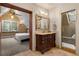 Elegant bathroom featuring a dark wood vanity, shower, and view of a bedroom at 848 S Emerson St, Denver, CO 80209