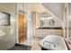 Stylish bathroom featuring a clawfoot tub, double vanity, and walk-in shower at 848 S Emerson St, Denver, CO 80209