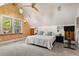 Spacious bedroom with slanted ceilings, carpeted floor and a fan at 848 S Emerson St, Denver, CO 80209