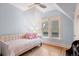 Light blue bedroom with a soft daybed and a view from the double windows at 848 S Emerson St, Denver, CO 80209