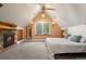 Relaxing bedroom featuring a stone fireplace, skylight and neutral decor at 848 S Emerson St, Denver, CO 80209