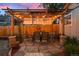 Charming pergola-covered dining area with a stone patio and a wooden fence at 848 S Emerson St, Denver, CO 80209