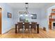 Traditional dining room with wood floors, table, chairs and hanging light fixture at 848 S Emerson St, Denver, CO 80209
