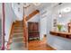 Welcoming entryway with hardwood floors, staircase, and a charming vintage cabinet at 848 S Emerson St, Denver, CO 80209