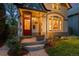 Quaint home exterior with a red front door, a well-maintained lawn, and fresh landscaping at 848 S Emerson St, Denver, CO 80209