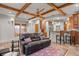 Open floor plan features leather sofa, beam ceiling, and access to gourmet kitchen at 848 S Emerson St, Denver, CO 80209